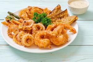 Deep-fried seafood, shrimp and squid with mix vegetables - unhealthy food style photo