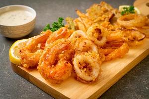 Deep-fried seafood, shrimp and squid with mix vegetables - unhealthy food style photo