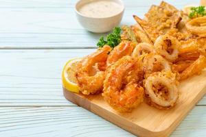 Deep-fried seafood, shrimp and squid with mix vegetables - unhealthy food style photo