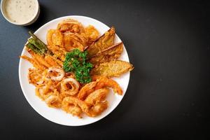 Deep-fried seafood, shrimp and squid with mix vegetables - unhealthy food style photo