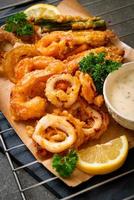 Deep-fried seafood, shrimp and squid with mix vegetables - unhealthy food style photo