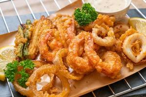 Deep-fried seafood, shrimp and squid with mix vegetables - unhealthy food style photo