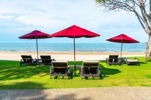 Beach chairs and umbrellas with ocean sea beach background