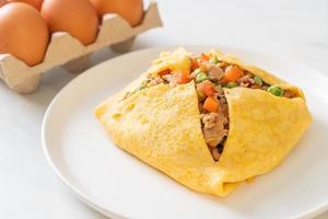 Egg wrap or stuffed egg with minced pork, carrot, tomato, and green peas photo