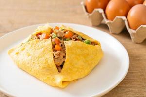 Egg wrap or stuffed egg with minced pork, carrot, tomato, and green peas photo