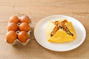 Egg wrap or stuffed egg with minced pork, carrot, tomato, and green peas photo