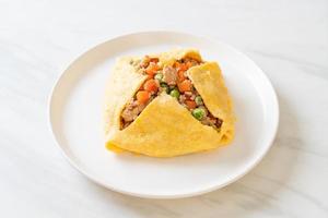 Egg wrap or stuffed egg with minced pork, carrot, tomato, and green peas photo