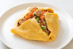 Egg wrap or stuffed egg with minced pork, carrot, tomato, and green peas photo