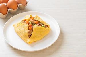 Egg wrap or stuffed egg with minced pork, carrot, tomato, and green peas photo