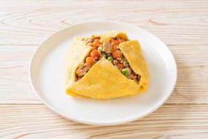 Egg wrap or stuffed egg with minced pork, carrot, tomato, and green peas photo