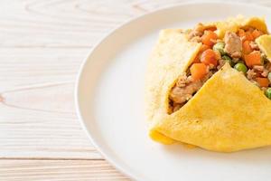 Egg wrap or stuffed egg with minced pork, carrot, tomato, and green peas photo