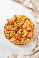 Seafood of shrimp, octopus, mussel, and crab pizza on wood tray photo