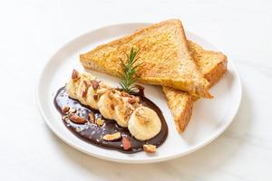 French toast with banana, chocolate, and almonds for breakfast photo