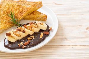 French toast with banana, chocolate, and almonds for breakfast photo