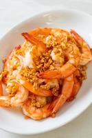 Fried shrimps or prawns with garlic on white plate - seafood style photo