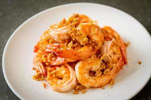 Fried shrimps or prawns with garlic on white plate - seafood style photo