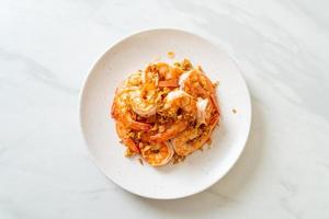 Fried shrimps or prawns with garlic on white plate - seafood style photo