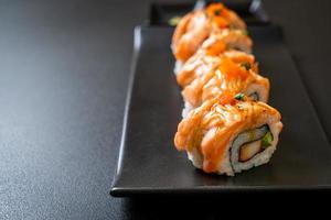 Grilled salmon sushi roll with sauce - Japanese food style photo