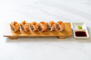 Grilled salmon sushi roll with sauce - Japanese food style