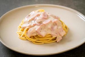 Homemade spaghetti white cream sauce with ham - Italian food style photo