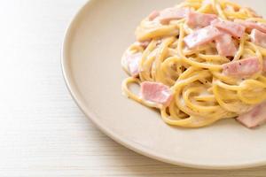 Homemade spaghetti white cream sauce with ham - Italian food style photo