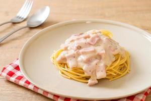 Homemade spaghetti white cream sauce with ham - Italian food style photo