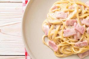 Homemade spaghetti white cream sauce with ham - Italian food style photo