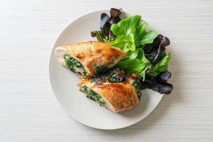 Baked chicken breast stuffed with cheese and spinach photo