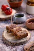 Indian Food Chicken Seekh Kebab on a Wooden Platter with Sauce photo