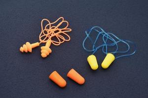 Earplugs isolated on dark background photo