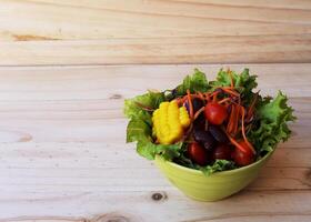 Fresh vegetable salad on Wooden backgrounds photo