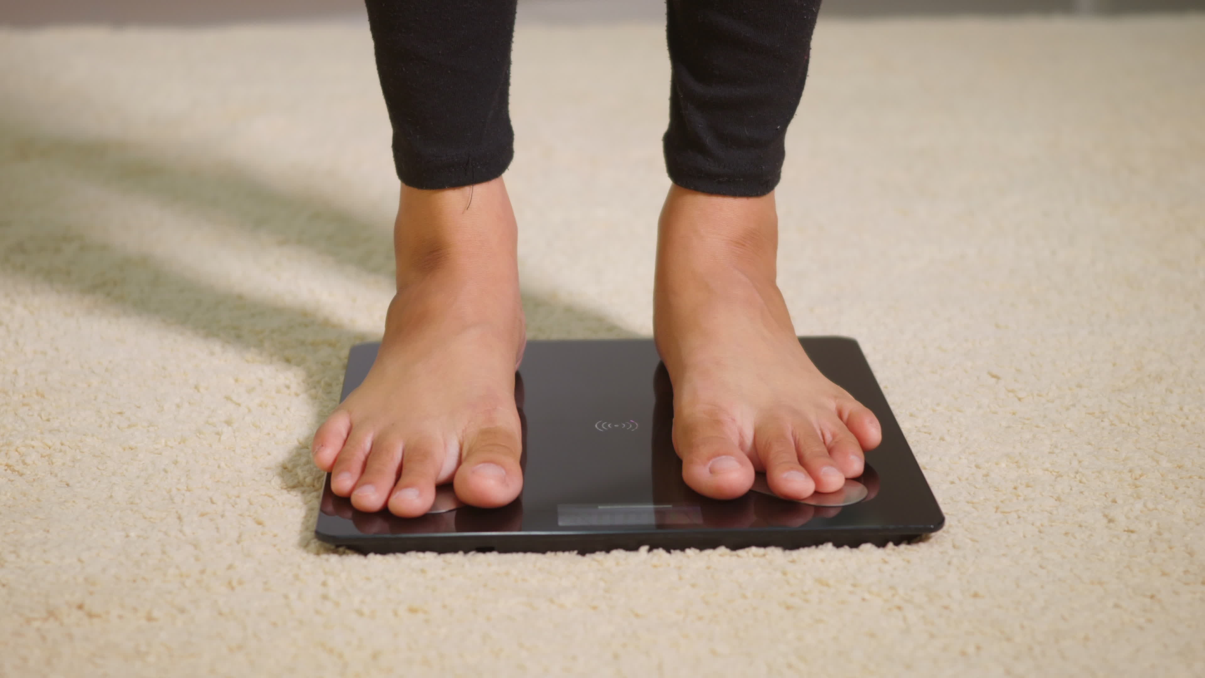 Woman standing on fitness scale, Stock Video