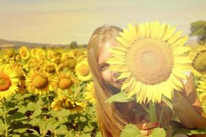 Smiling young woman in field sunflowers, farming time in countryside photo