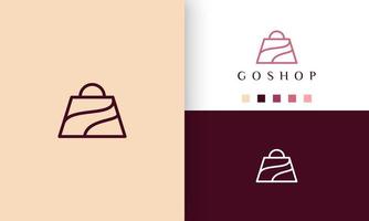 Logotipo de la bolsa de compras en estilo simple y artístico. vector