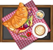 Breakfast croissant sandwich with a cup of coffee on a wooden plate isolated vector