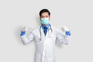 Handsome Pakistani doctor and stethoscope with mask on face, pointing oneself with fingers proud and happy. photo