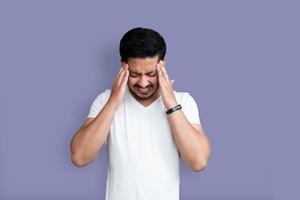 Man with hands on forehead in pain photo