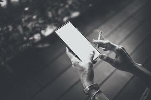 Woman's hands and smartphone with cigarettes. photo