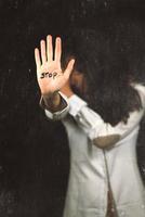 Stop violence against women. Hand saying stop. photo