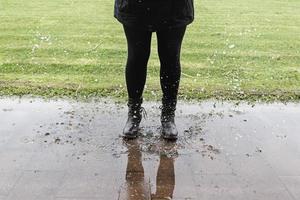 Woman jumping puddle photo