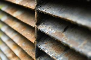 Close-up of rusty metal lattice wall photo