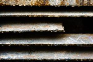 close up of rusty metal lattice wall, grunge texture, abstract brown textured lines, old iron construction isolated background, brown dirty metallic surface, material covered by rust, rough backdrop photo