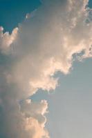 Deep blue sky and high clouds in the sun rays at sunset photo