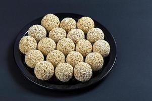 Amaranth ladoo or Rajgira laddu or Cholai ke laddo in black plate on black background. photo