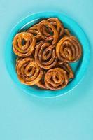 Indian sweet jalebi, indian dessert jalebi or imarti or imarati or jilbi on blue background photo