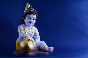 Hindu God Krishna on blue background photo