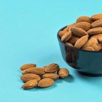Close-up of Almonds on blue background photo