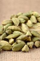 Green Cardamom pods on sack cloth photo