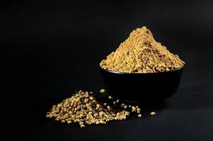 Coriander Powder and Coriander seeds on black background photo