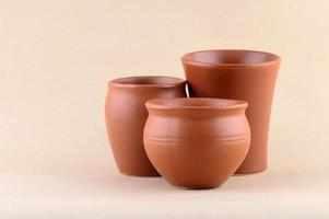 Close-up of Clay pots on cream color background photo